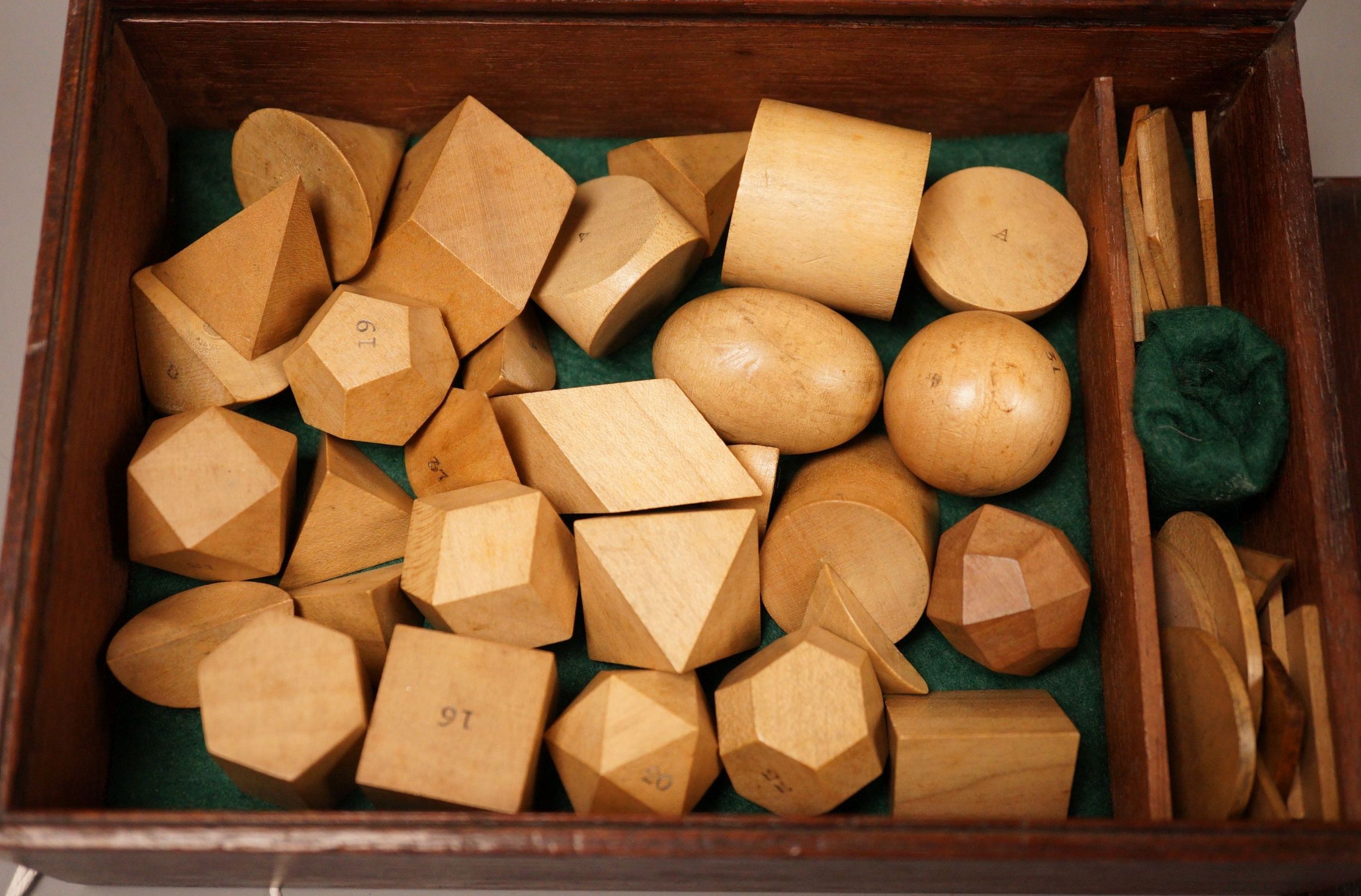 A mahogany cased set, Edwards Geometrical Planes and Solids': 19th century educational carved wooden geometry instructional set, with paper label to cover